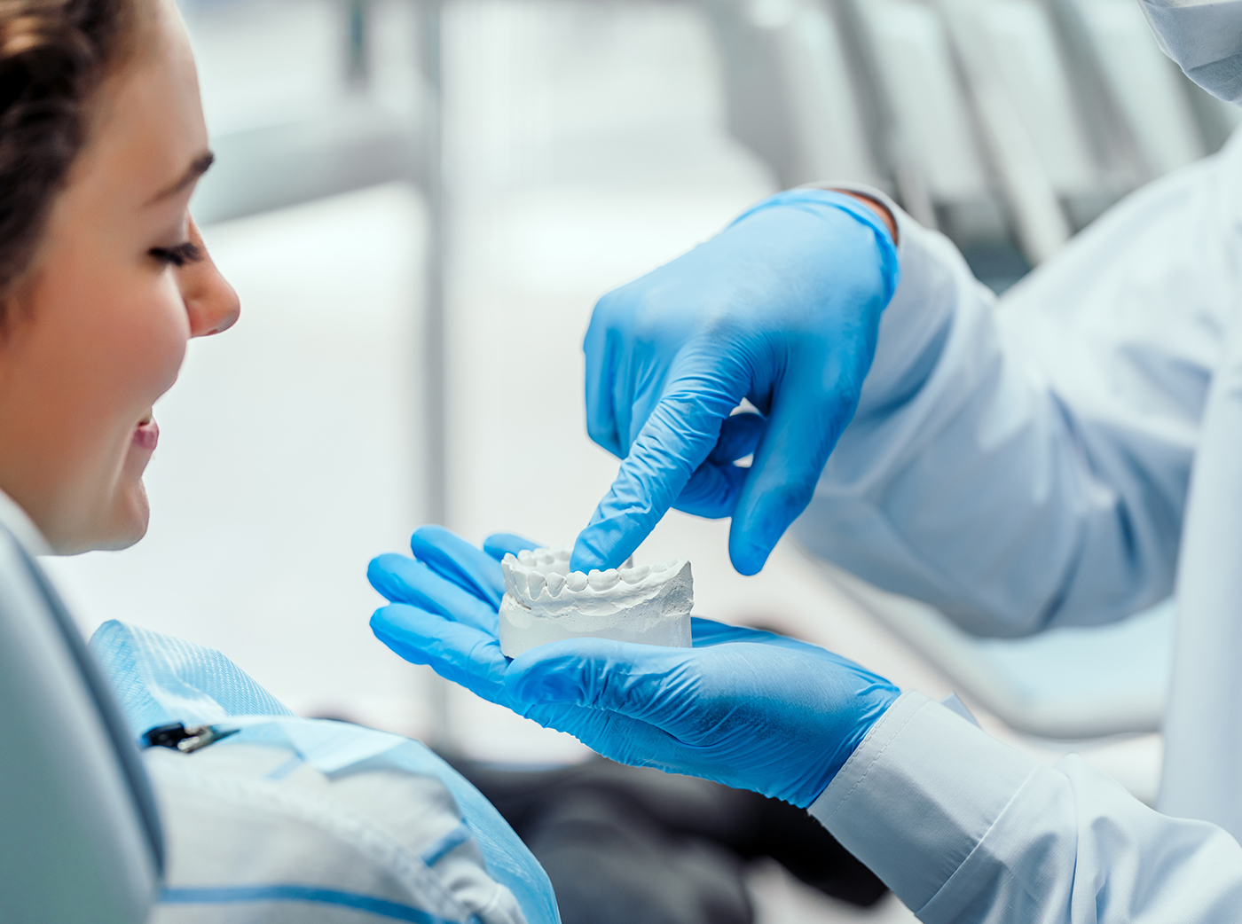 Dentist explaining the details of dental mold to his patient